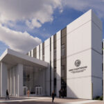 A modern courthouse building with trees and a clear sky.