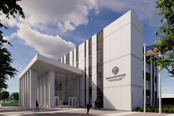 A modern courthouse building with trees and a clear sky.