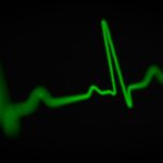 green heartbeat line on a black background