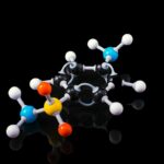 A molecular model of a peptide structure with colorful atoms connected by bonds on a black background.