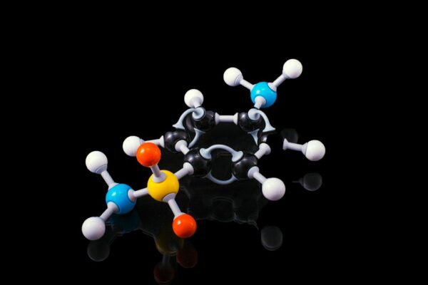 A molecular model of a peptide structure with colorful atoms connected by bonds on a black background.
